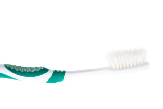 Green worn toothbrush on white background