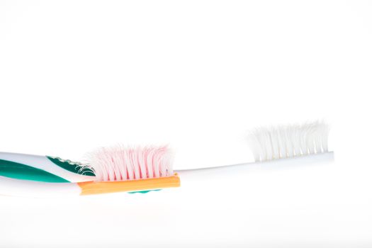 Two Color worn toothbrush on white background