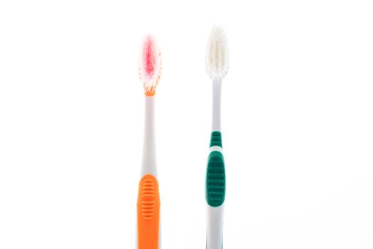 Two Color worn toothbrush on white background