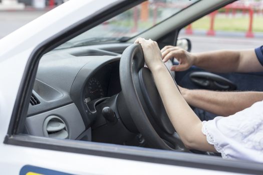 Close up of woman's hand driving a car