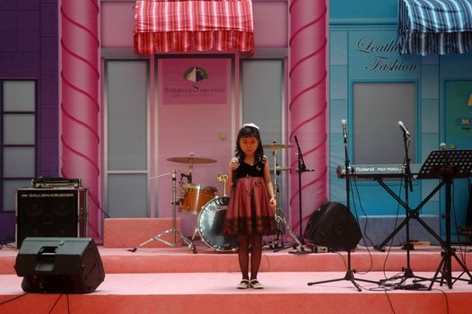 bandung, indonesia-december 17, 2011: girl contestant at bandung supermall singing contest.