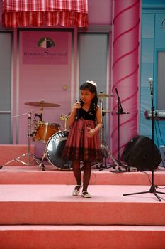 bandung, indonesia-december 17, 2011: girl contestant at bandung supermall singing contest.