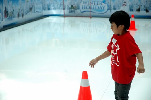 bandung, indonesia-december 17, 2011: boy learning inline skate at bandung supermall venue.