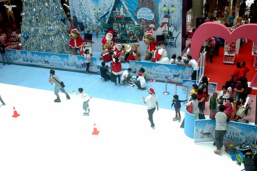 bandung, indonesia-december 17, 2011: girl and boy learning inline skate at bandung supermall venue.