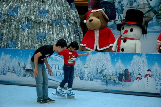 bandung, indonesia-december 17, 2011: girl learning inline skate at bandung supermall venue.