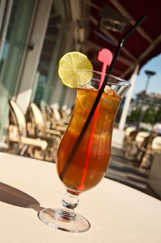 glass of ice tea with lemon in outdoor terrace