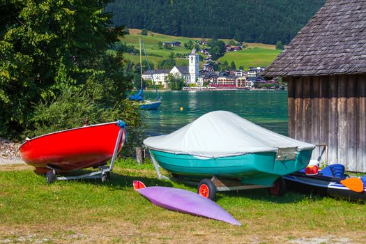 View of St. Wolfgang village waterfront at Wolfgangsee lake with beach toys in front, Austria