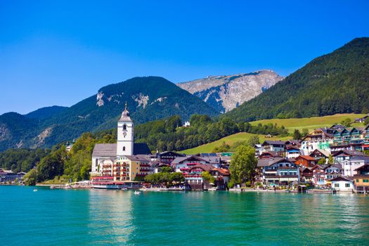 View of View of St. Wolfgang chapel and the village waterfront at Wolfgangsee lake, Austria
