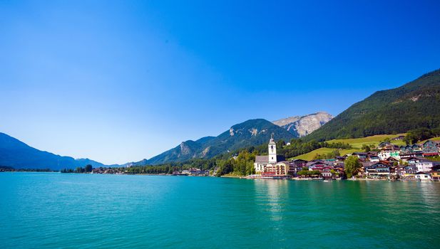 View of View of St. Wolfgang chapel and the village waterfront at Wolfgangsee lake, Austria