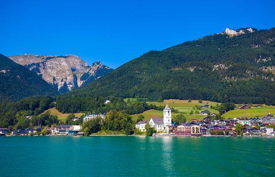 View of View of St. Wolfgang chapel and the village waterfront at Wolfgangsee lake, Austria