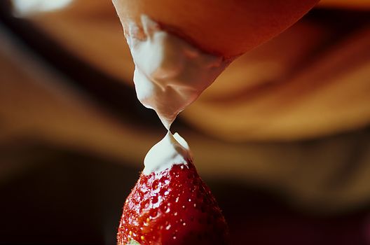 Strawberry Breast 067. A strawberry and a woman's breast both with cream.