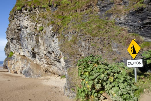 beware of cliff falls warning sign beside the cliffs in Ballybunion county Kerry Ireland