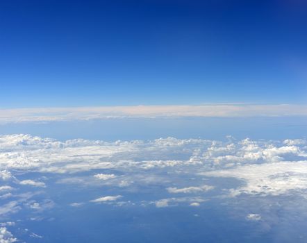 Blue sky and clouds. Top view of aircraft