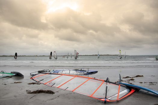 wind surfers racing in the storm winds on the wild atlantic way in county Kerry Ireland