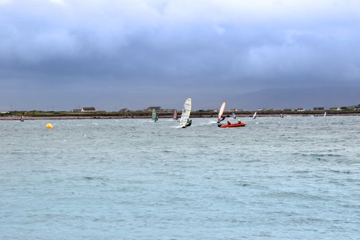 wind surfers racing in the storm winds on the wild atlantic way in county Kerry Ireland