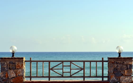 Railing with lights on background of sea and sky