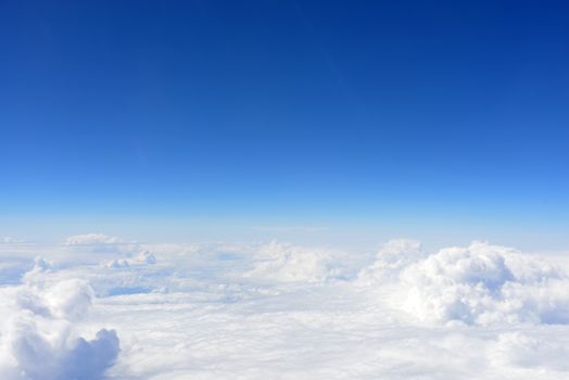 Blue sky and clouds. Top view of aircraft