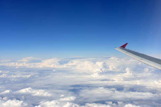 Airplane wing on a background of clouds