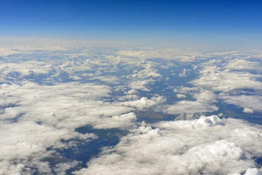 Blue sky and clouds. Top view of aircraft