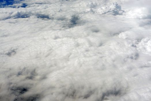 Blue sky and clouds. Top view of aircraft