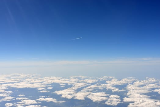 Blue sky and clouds. Top view of aircraft