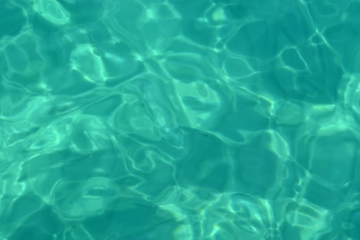 Turquoise water surface in the pool. Close up