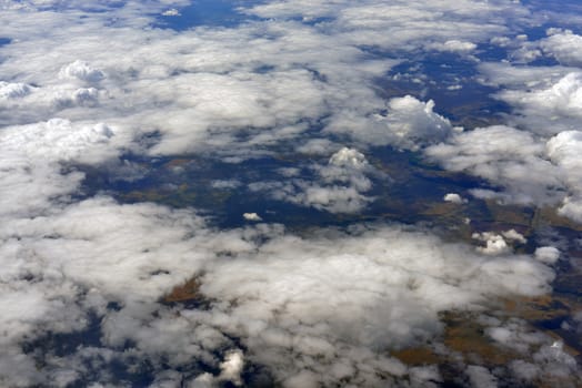 Blue sky and clouds. Top view of aircraft