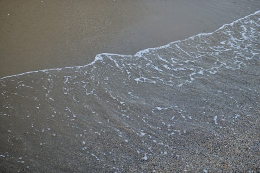 Seawater on the sandy beach. Natural background