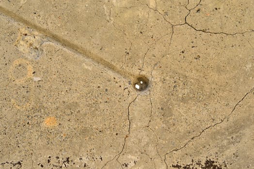 The old, cracked concrete surface. Close up