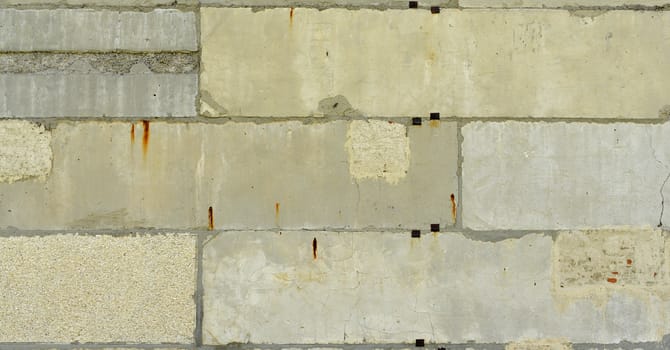Old, cracked surface of concrete and bricks. Close up