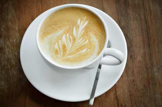 Cappucino coffee cup on wooden table