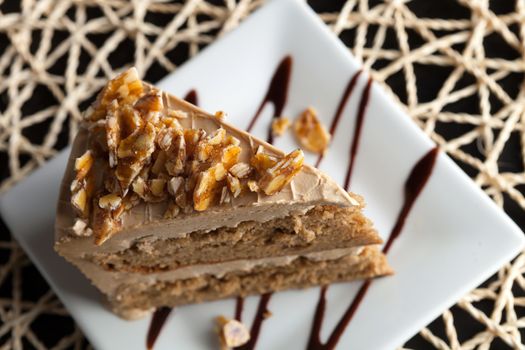 Slice of almond toffee cake with coffee flavored icing.