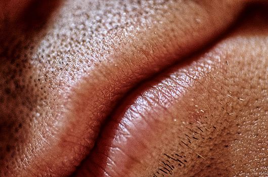 A Man's Lips 100. A man's lips and beard stubble.