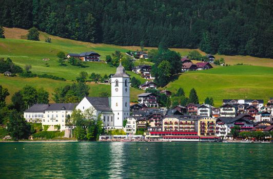 View of St. Wolfgang village waterfront at Wolfgangsee lake with beach toys in front, Austria