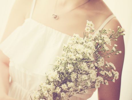 Bride or bridemaid with bouquet, closeup with retro filter effect