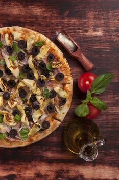 Delicious pizza with olive oil, fresh tomatoes and basil on wooden background, top view. Culinary italian cuisine. 