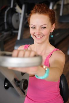 young red haired girl doing hands spinning machine workout