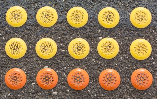 mixed rubber button color on the ground at the train station