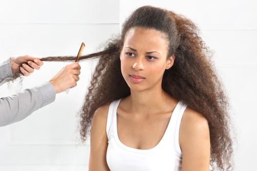 The dark-skinned woman in a hair salon