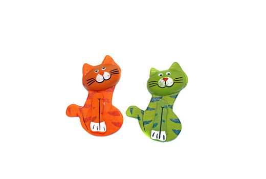 Two wooden cat figure brightly painted in orange and green