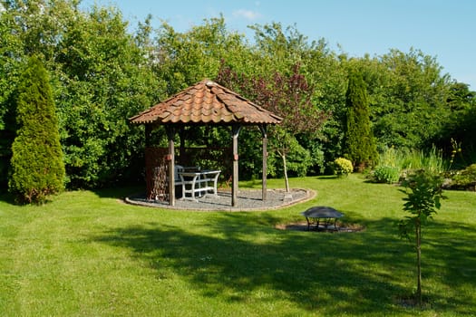   Beautiful decorative home garden yard gazebo pavilion in the summer                                  