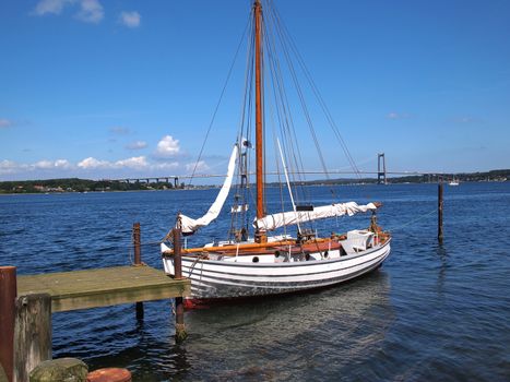 Old vintage traditional wooden sail boat in Middelfart Marina Denmark
