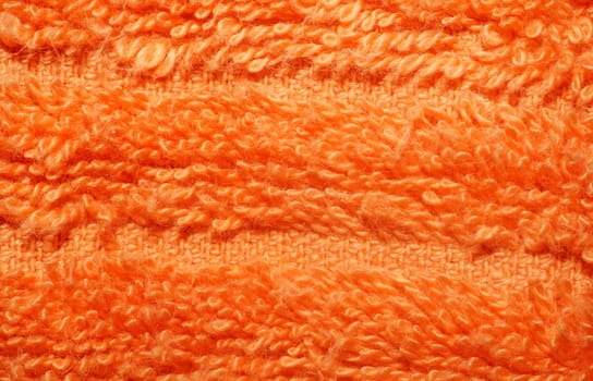 Texture of bright orange terry towels very closeup