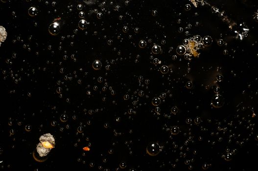 Abstract background - black water surface with bubbles