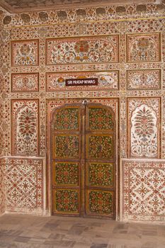 Highly decorated wall and door inside the Royal Palace at Bikaner Rajasthan India