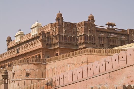 Red sandstone walls of Junagarh Fort enclosing exquisitely carved palace buildings. Bikaner, Rajasthan, India