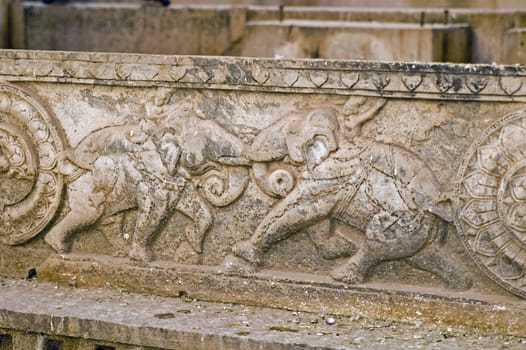 Carving of elephants fighting decorating the walls of the Rani-ki Baoli step-well in Bundi, India