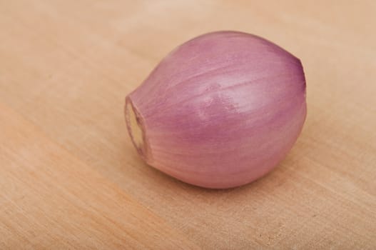 Shallot  isolated peeled on wooden  background