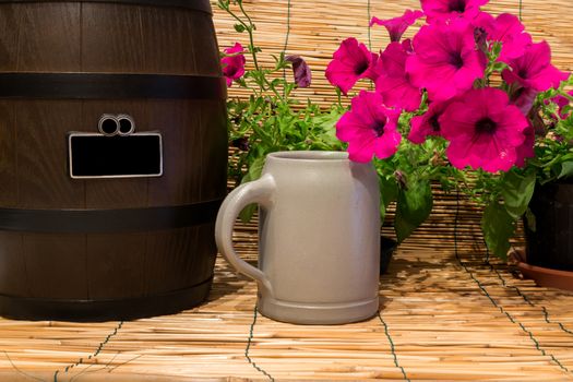 Still life of a small beer barrel with some flowers