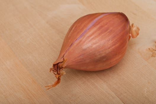 Shallot isolated on wooden  background